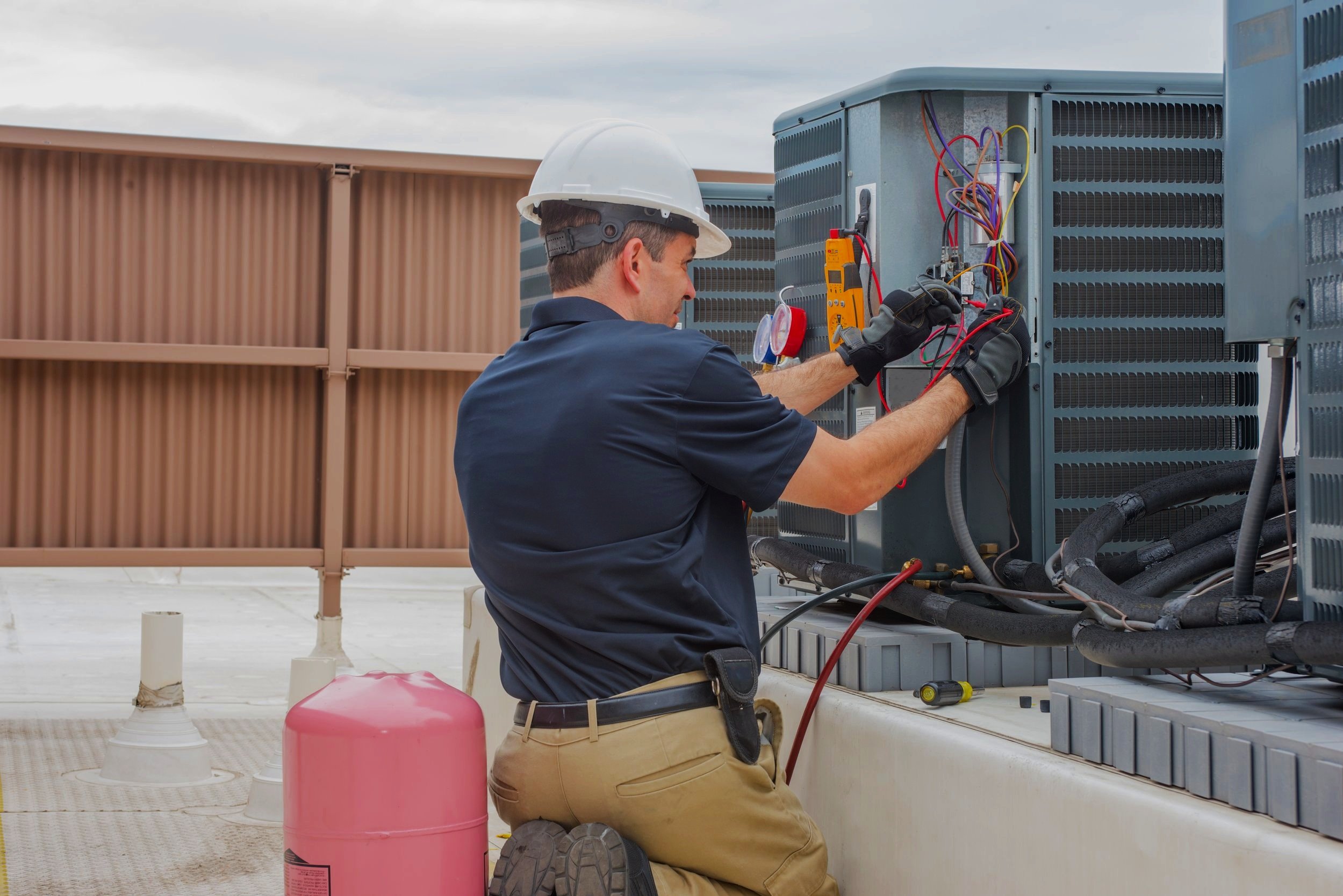 Blue Line technician servicing a residential AC condenser unit